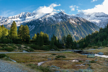 Obraz premium Mountain road through alpine valley with snowy mountains in the Krimmler Achental, Austria
