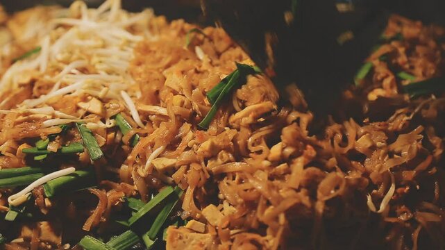 close up of moving wok with a pad thai