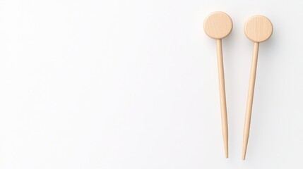 Two wooden chopsticks with circular ends on a white background.