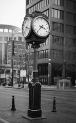 clock on the street in black and white