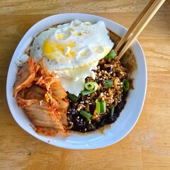Korean food jjajangmyeon with fried eggs and kimchi