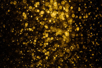 Blurred photo with golden dots visible glittering, shining brightly look and feel luxurious