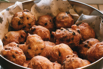 Oliebollen fresh Dutch pastry in a bowl. New years treat in the Netherlands. Happy New Year snack.