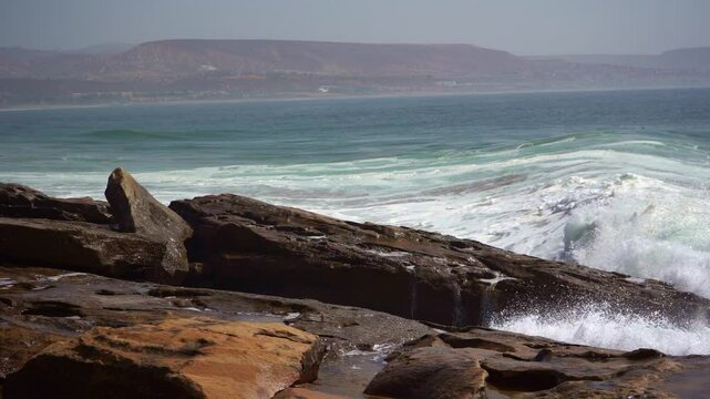 a big wave hit beachrocks hard and make big splashes in slow motion, anchor point.