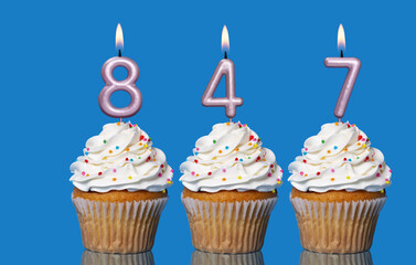 Birthday Cupcakes With Candles Lit Forming The Number 847