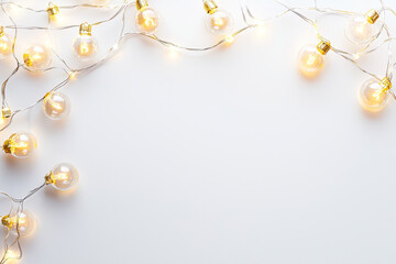 Decorative string lights with glowing bulbs on white background
