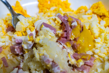 mixing the ingredients of the egg sandwich