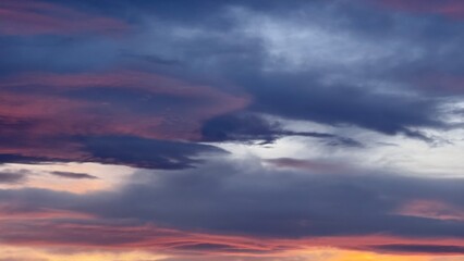 A sunset sky with shades of pink, lavender, and blue. Clouds form a dramatic gradient, emphasizing the softness of light and a peaceful atmosphere.
