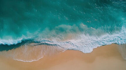 Aerial View Of Ocean Waves Crashing On Sandy Beach