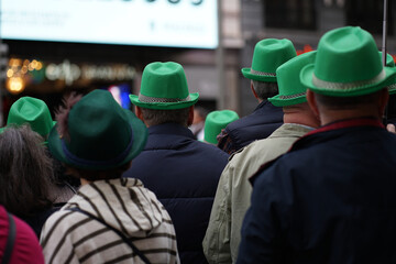 Spectators in green hats enjoy the St. Patrick's Day parade