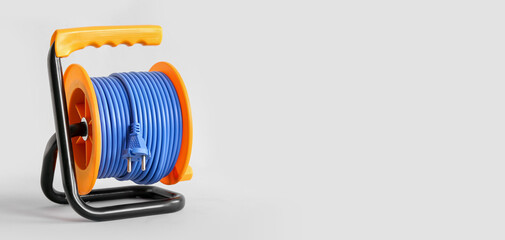 Blue extension electric cable reel on white background