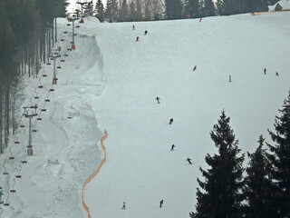 Ski slope with skiers, view from above.
