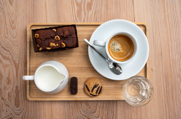 Brownie, coffee cup, mil, water, a coockie and Belgian chocolate serving in Koekelberg, Belgium