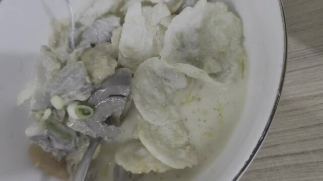 With a swift motion, a hand stirs the aromatic goat soup, a Jakarta classic, sending tantalizing steam into the air.