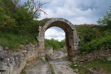 Orta-Kapu Gate (Northern Gate) of the ancient fortress Chufut-Kale on a cloudy May day Crimea