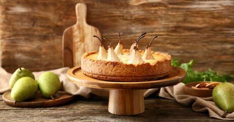 Stand with tasty pear cake on table