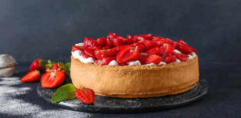 Board with tasty strawberry pie on dark background