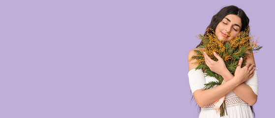 Beautiful young woman with bouquet of mimosa flowers on lilac background