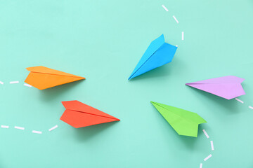 Composition with different paper planes on color background