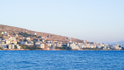 Fototapeta premium Stunning Albanian sunset over the sea, with Sarande seaside views.