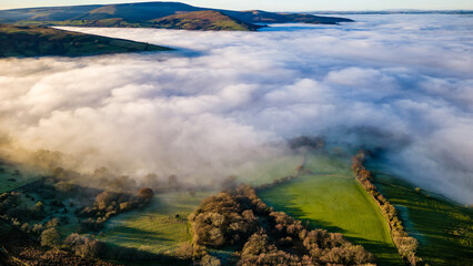 Aerial view of thick fog and farmland in late afternoon sunlight