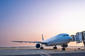 airplane jet waiting to runway on taxi lane in airport and aircraft traffic to take off with sunset background, view from window air plane