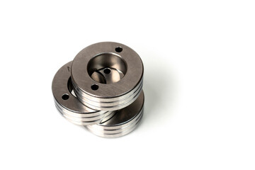 Set of metal washers on white background. Three round thick metal washers. industrial hardware for assembly and fastening.