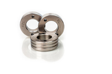 Set of metal washers on white background. Three round thick metal washers. industrial hardware for assembly and fastening.