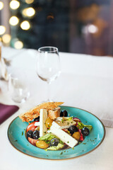 Greek salad with feta cheese, olives, vegetables, olive oil and bread. Healthy dish, organic food, White background.