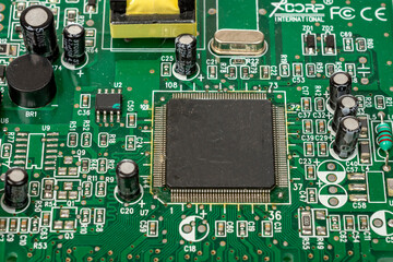 Electronic board with radio components, connectors, slots and processor chip from an electronic device, close-up