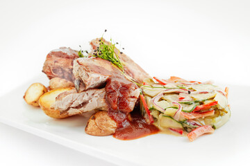 Grilled ribs, baked potatoes, pickled cucumber salad, Polish cuisine, European food, white background
