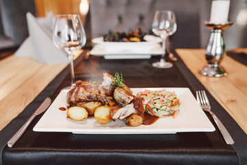 Grilled ribs, baked potatoes, pickled cucumber salad, Polish cuisine, European food
