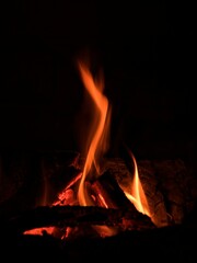 Flames of fire with embers. The scene radiates heat, passion, and energy, with dancing flames and radiant heat creating a captivating atmosphere. Perfect for the concept of comfort and romance