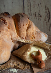 Matera bread, typical bread of basilicata region, italy, resting on rustic wooden table