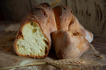 Matera bread, typical bread of basilicata region, italy, resting on rustic wooden table