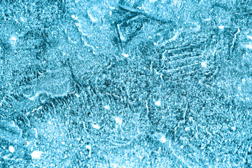 Shapes on the frozen surface of the lake in the winter with low temperatures in light blue color