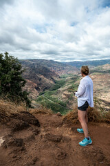 woman near Waimea canyon state park, view over the canyon, Kauai, Hawaii