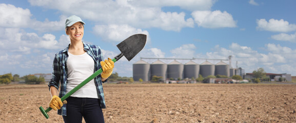 Female farmer holding a shovel on a field © Ljupco Smokovski