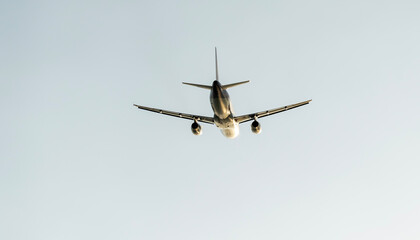 passenger airliner in the sky at sunset or dawn