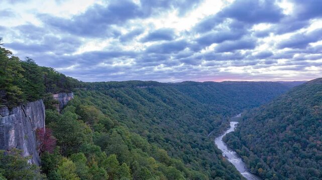 New River Gorge National Park, West Virginia, Endless Wall illuminated at sunrise during early autumn. 4k Time Lapse.