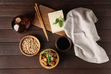 Bowl with pieces of fried tofu cheese and micro green on wooden background