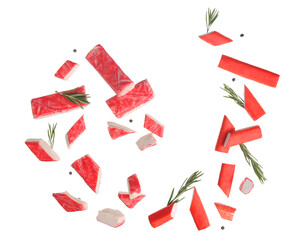 Cut tasty crab sticks with peppercorns and rosemary flying on white background © Pixel-Shot