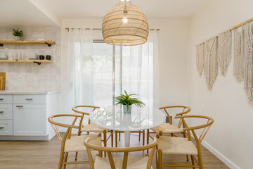 Modern Dining Area with White Table and Light Rattan Wood Chairs