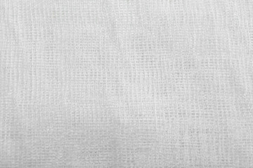 Texture of white gauze cloth as background, closeup