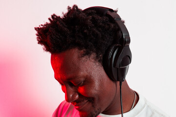 Portrait of black person enjoying music with headphones on