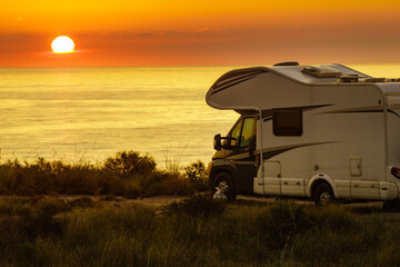 Caravan on sea at sunrise.