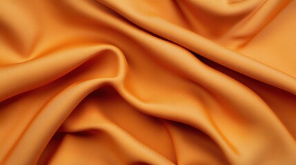 Close-up of an orange fabric with a smooth, flowing texture