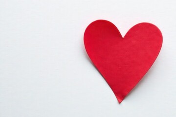 Fototapeta premium Vibrant red heart, smooth painted surface, white backdrop , romance, image