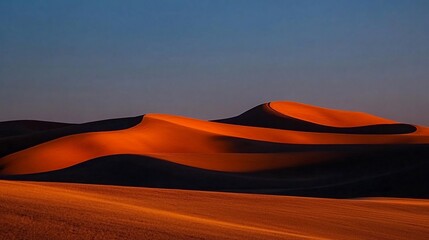 Sunset illuminating orange sand dunes.