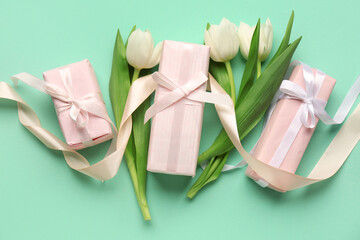 Gift boxes with tulips on turquoise background. Happy Women's Day